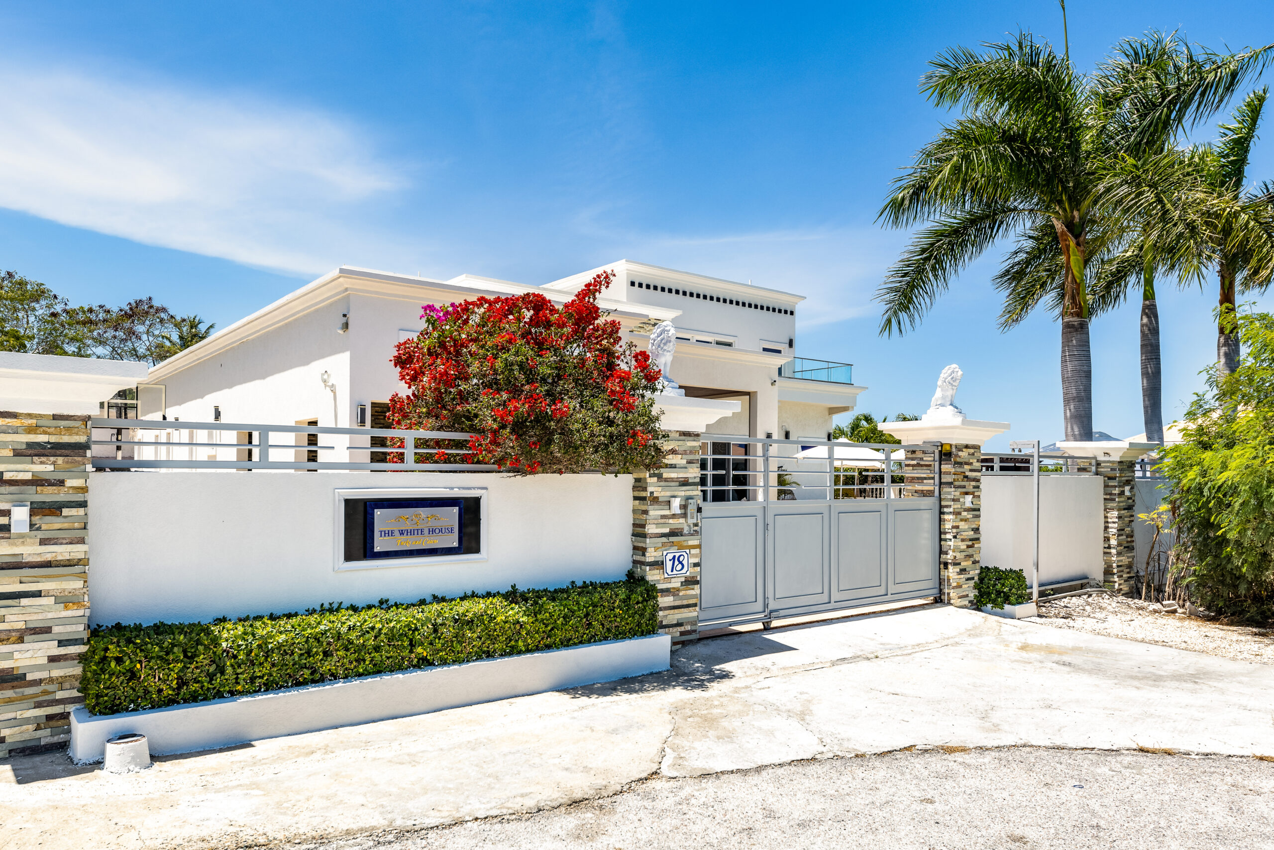 Gated entrance and property sign at The White House TCI villa in Providenciales