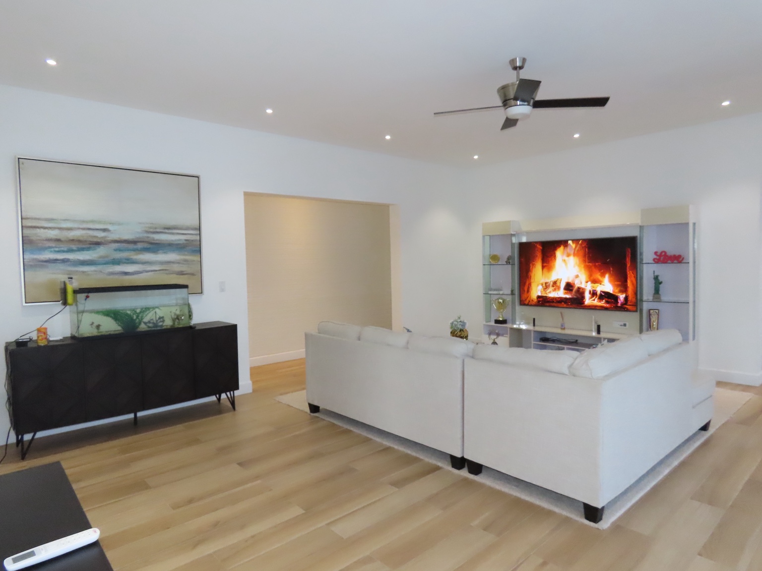 Bright guest house living room with sofas and large TV