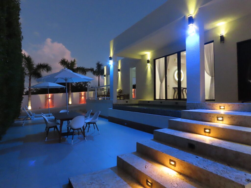 Guest house terrace and outdoor seating beside the pool at dusk in Providenciales