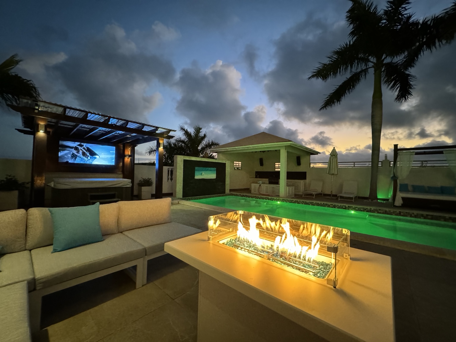 Poolside lounge and fire pit at dusk at The White House TCI in Providenciales