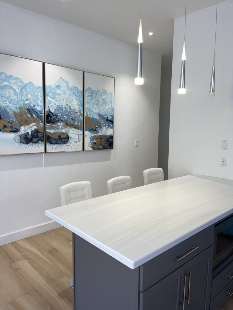 Guest house kitchen island with dining seats and pendant lighting